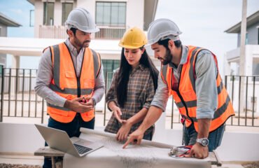 civil-engineer-construction-worker-architects-wearing-hardhats-safety-vests-are-working-together-construction-site-building-home-cooperation-teamwork-concept